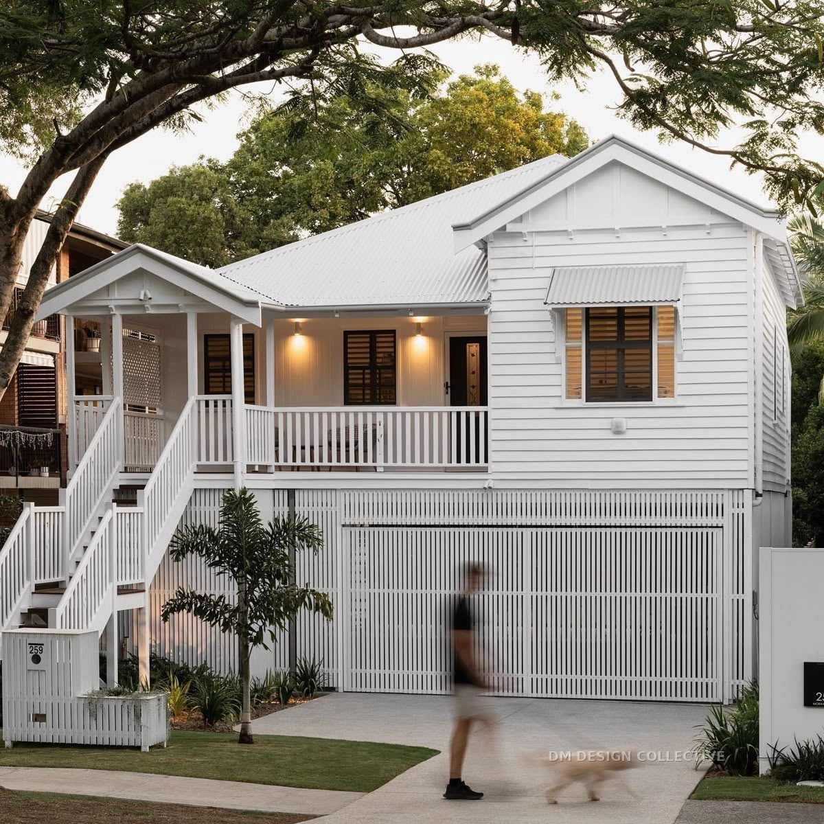Raised Queenslander home elevated on new posts with built-under garage — house raising design