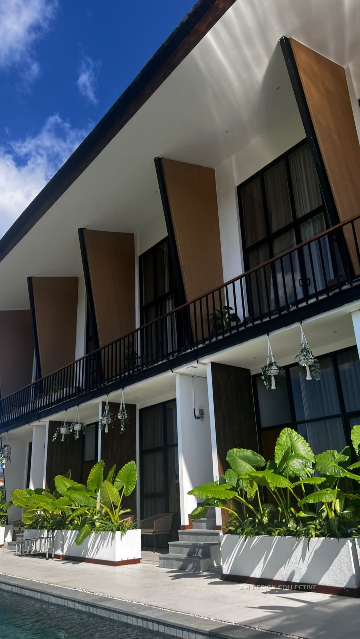 Completed DM Design Collective rooming accommodation project — two-storey building with private balconies and landscaped shared areas